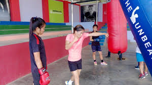 A young female boxer mary kom training in a gym, symbolizing Mary Kom's early boxing journey
