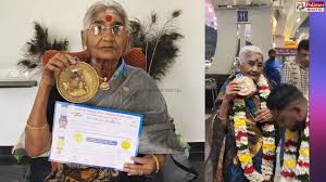 82-year-old Kittammal lifting weights at a powerlifting competition, showcasing her strength and determination.