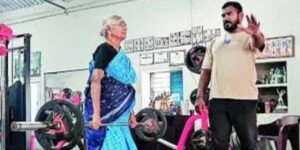 82-year-old Kittammal lifting weights at a powerlifting competition, showcasing her strength and determination.